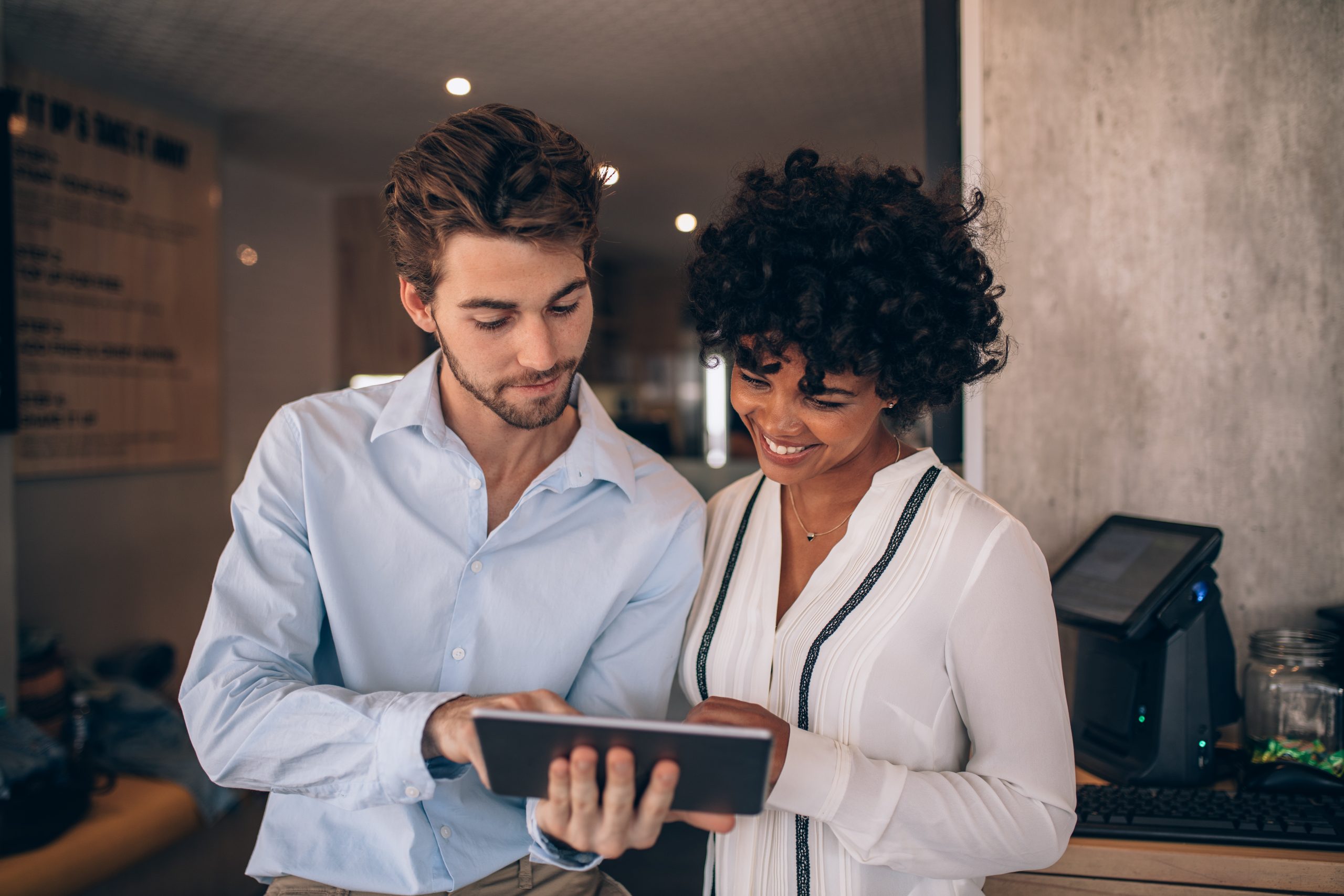 Business partners reviewing their work together on a digital tablet
